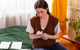 Portrait of young female managing personal finances,...