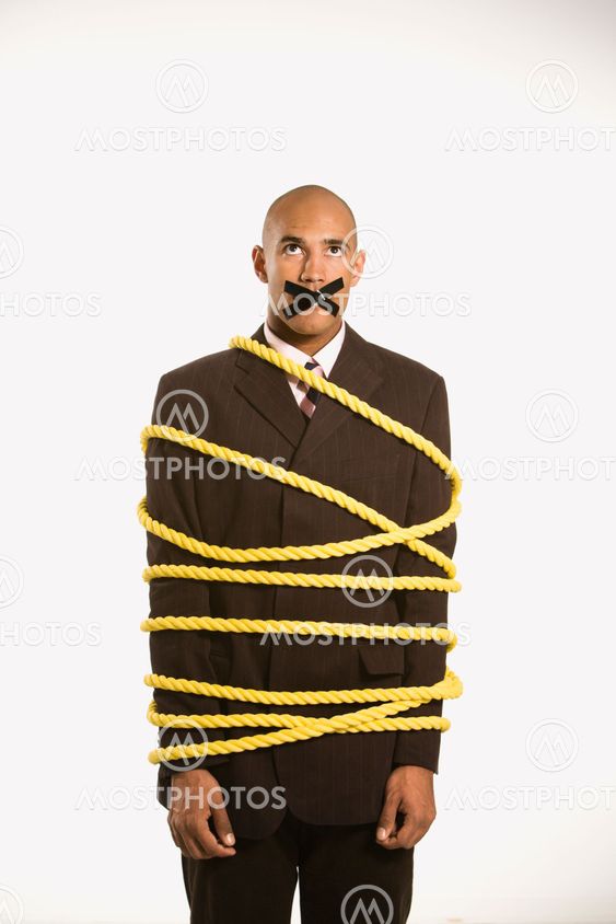 Businessman tied in rope.