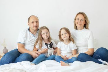 Young family relaxing on the couch together at home