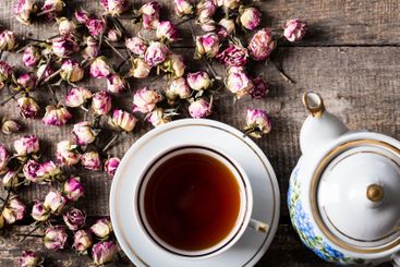 Vintage teapot and cup with blooming tea flowers on...