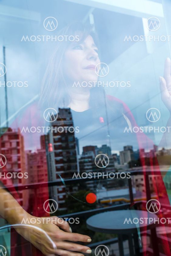 Mature woman looking out the window