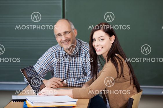 Student and lecturer working on a laptop