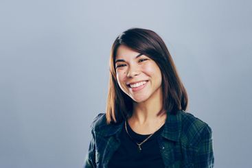 Creative, smile and portrait of woman in studio with...