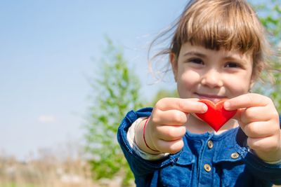 The heart is in the hands of the child. Selective focus.