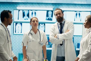 Doctor specialists reviewing human anatomy scans via...