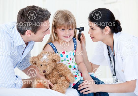Smiling girl looks happy with her teddy bear