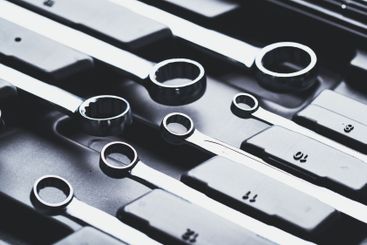 Various sizes of metal wrenches arranged neatly on a...