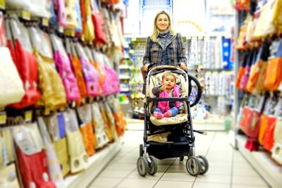 family mother baby son supermarket stroller