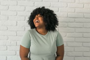 African American woman expressing pure joy with an...