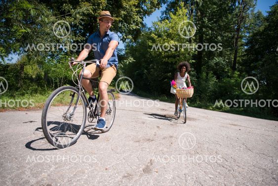 Young multiethnic couple having a bike ride in nature