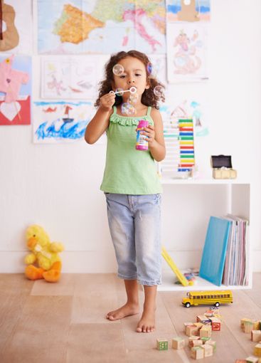 Kid, toy and blowing bubbles for childhood development,...