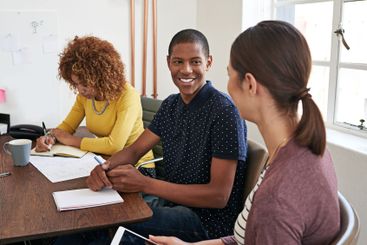 Discussion, writing and creative team in office with...