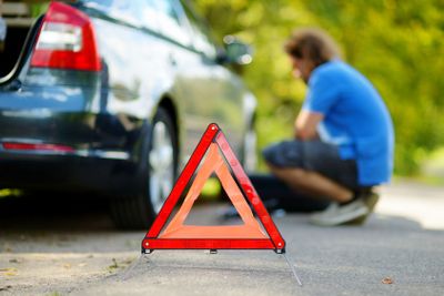 Red warning triangle sign on the road