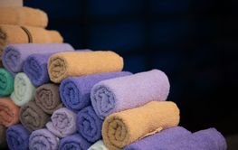 Neatly folded colorful towels arranged in a hospital...