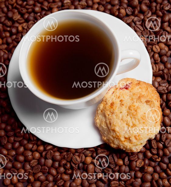 Coffee in white cup with cookies, beans