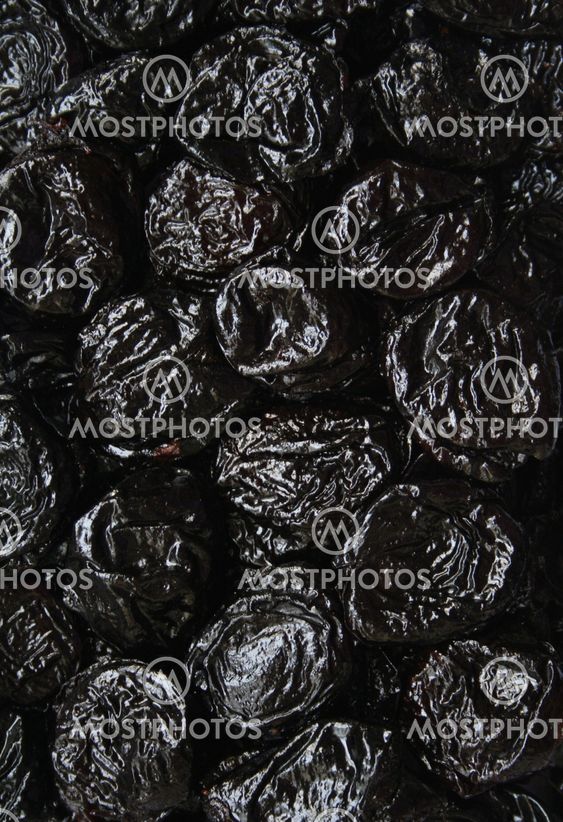 Dry plums or prunes fruit as background