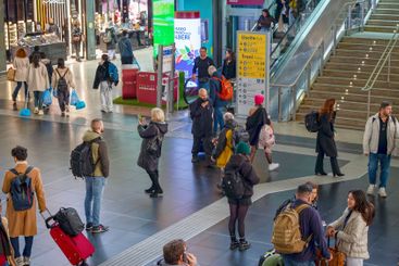 Travelers inside the Roma Termini railway station, in...