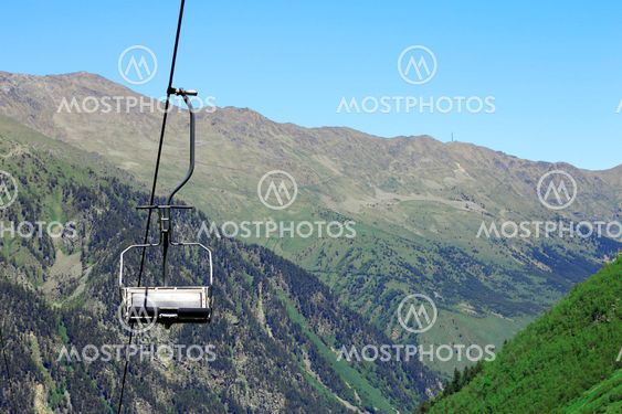 Empty cableway and caucasus mountains background