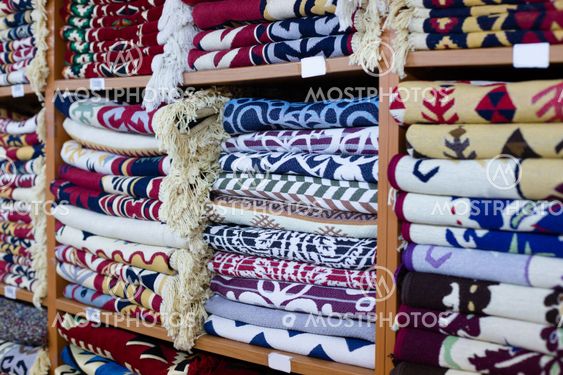 Shelves with blankets stacks in shop.