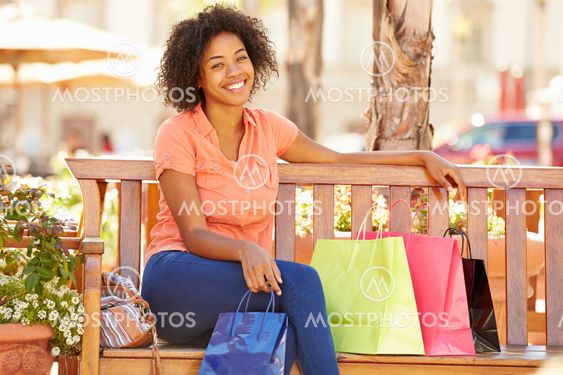 Woman Resting With Shopping Bags Sitting In Mall