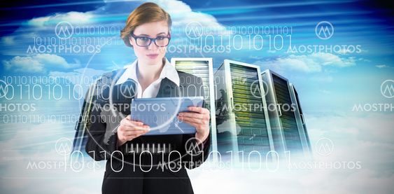 Composite image of redhead businesswoman using her tablet pc
