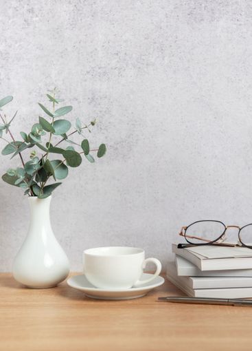 Eucalyptus branches, coffee cup, books and eyeglasses...