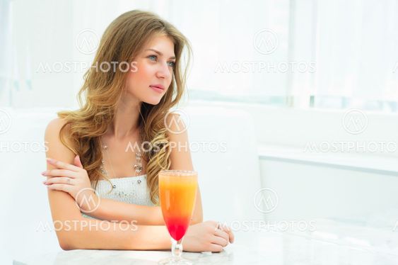 Portrait of a cute woman in a city cafe