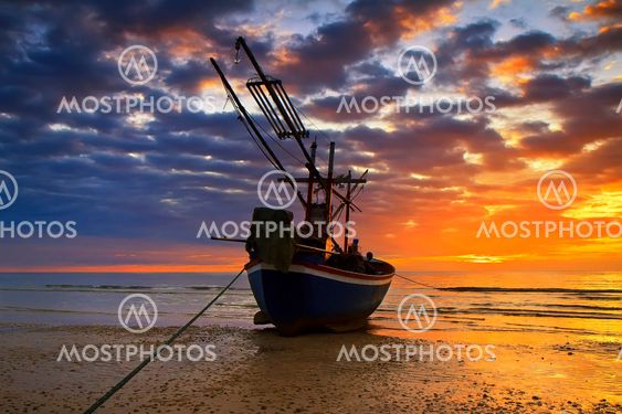 Sunset over the ocean and fishing boat
