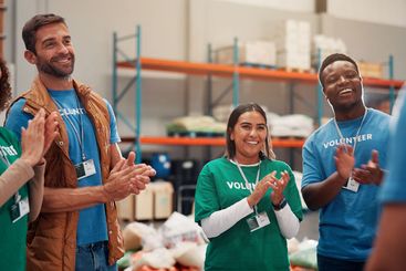 Volunteer group, teamwork and celebration with applause...