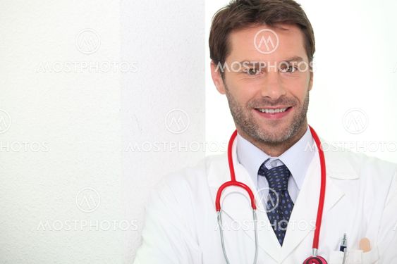 Male doctor stood smiling