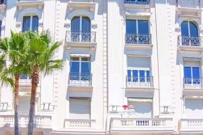 Daylight sunny view to hotel facade with balconies and...