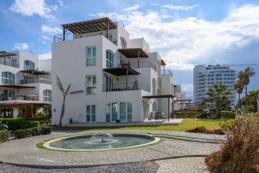 Luxury seaside villa surrounded by lush greenery with a...