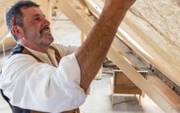 Construction woodworker measuring on site