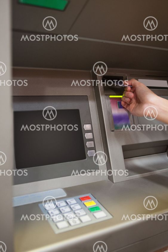Portrait of a hand inserting a credit card