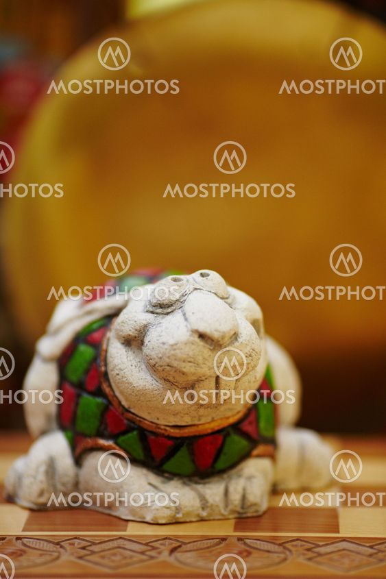 Figurine of chameleon on a chess-board.