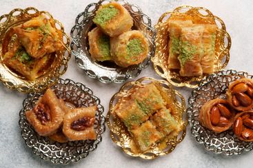 Assorted traditional pastries served on decorative...