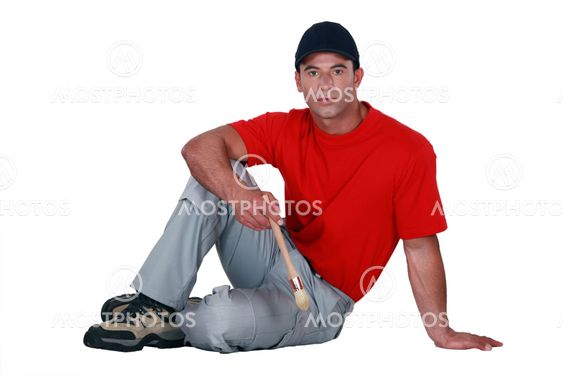 Austere man holding a paintbrush