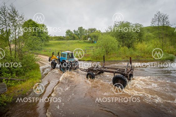 tractor crosses the river