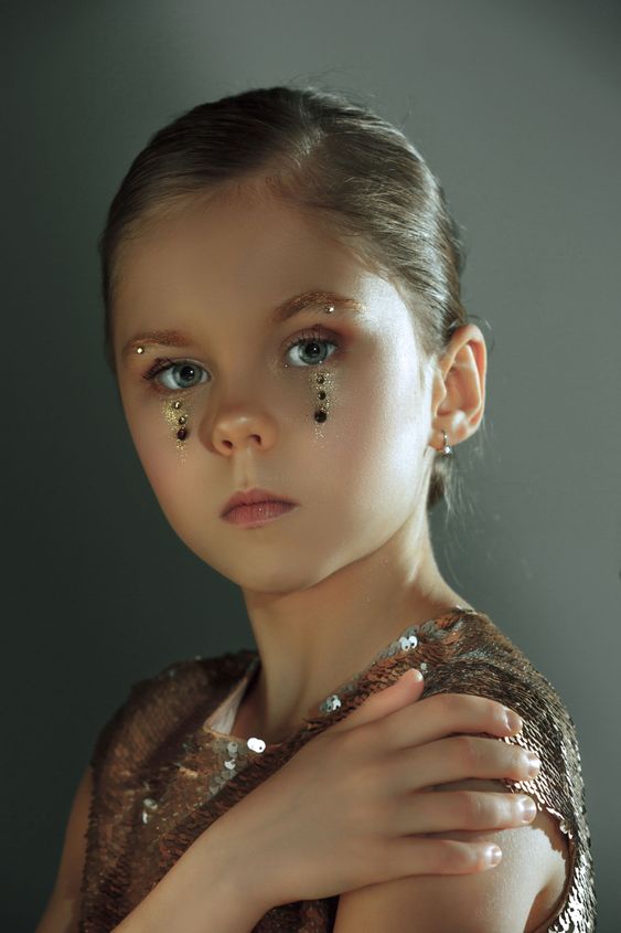 The fashion portrait of young beautiful teen girl at studio