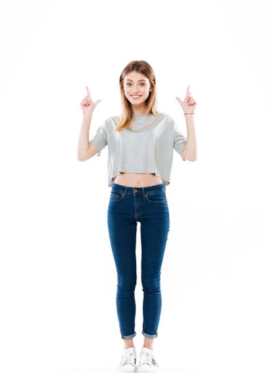 Full length portrait of a cheerful cute girl standing