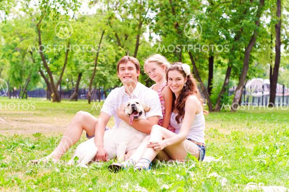 Happy young family with Labrador