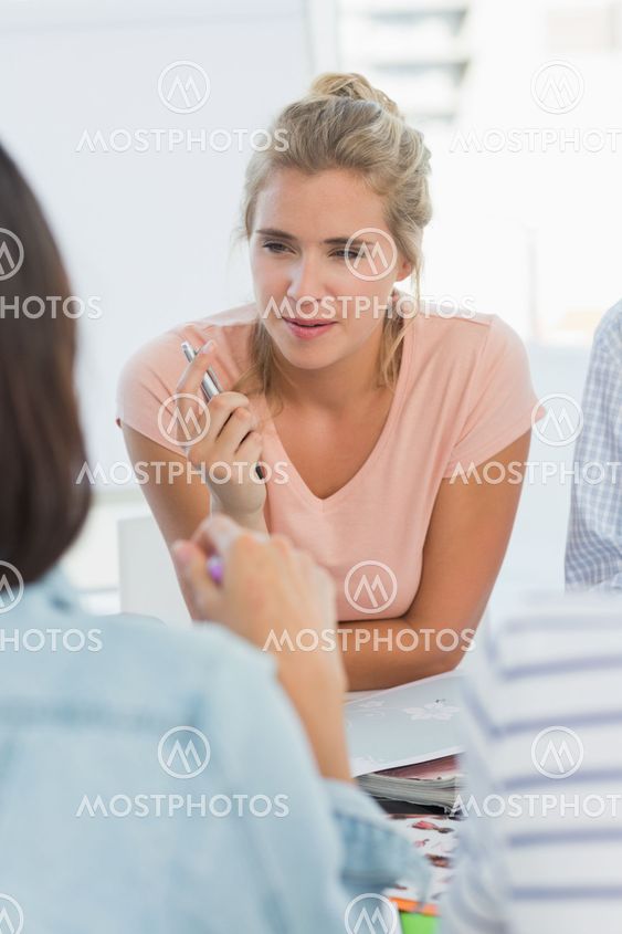 Smiling design team talking at a meeting