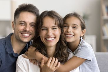 Authentic beautiful Latin parents and daughter smiling...