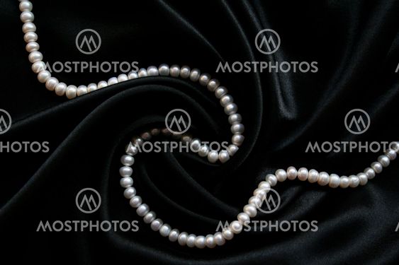 White pearls on the black velvet background