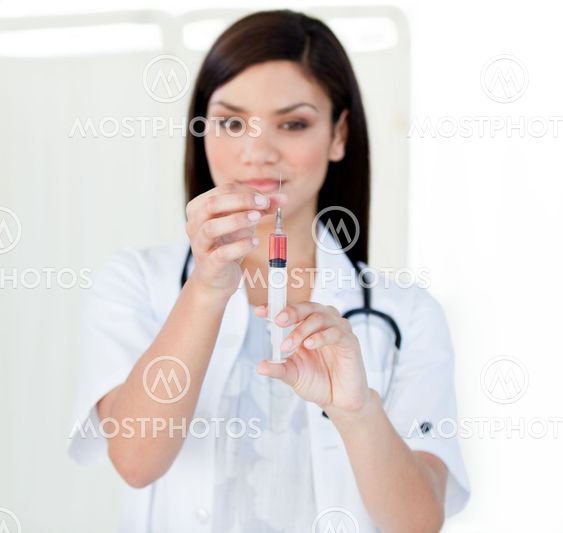 Portrait of a beautiful female doctor preparing a syringe