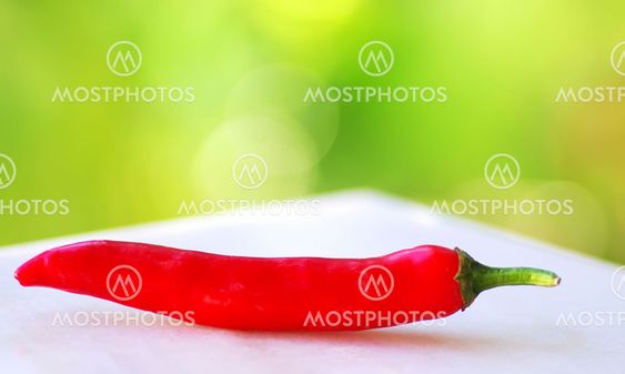 red hot chili pepper isolated on a green background