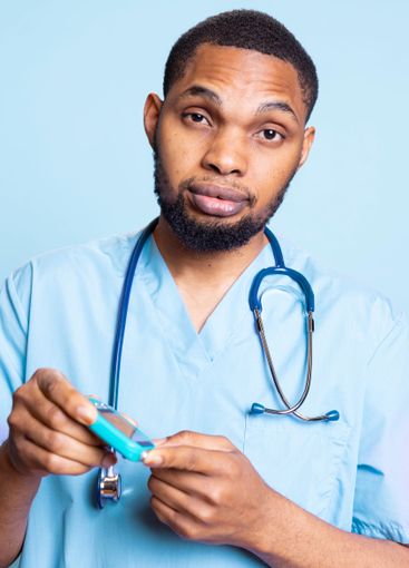 Professional medic posing with glucometer to measure...