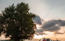 Woman near car. Sunset in the mountains