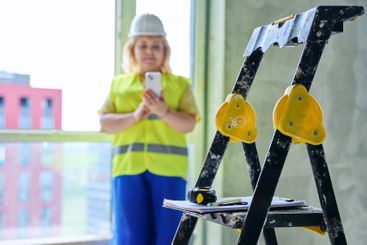 Close-up of construction tools, female industrial worker...