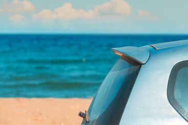 Car at the seaside beach in summer morning, travel and...
